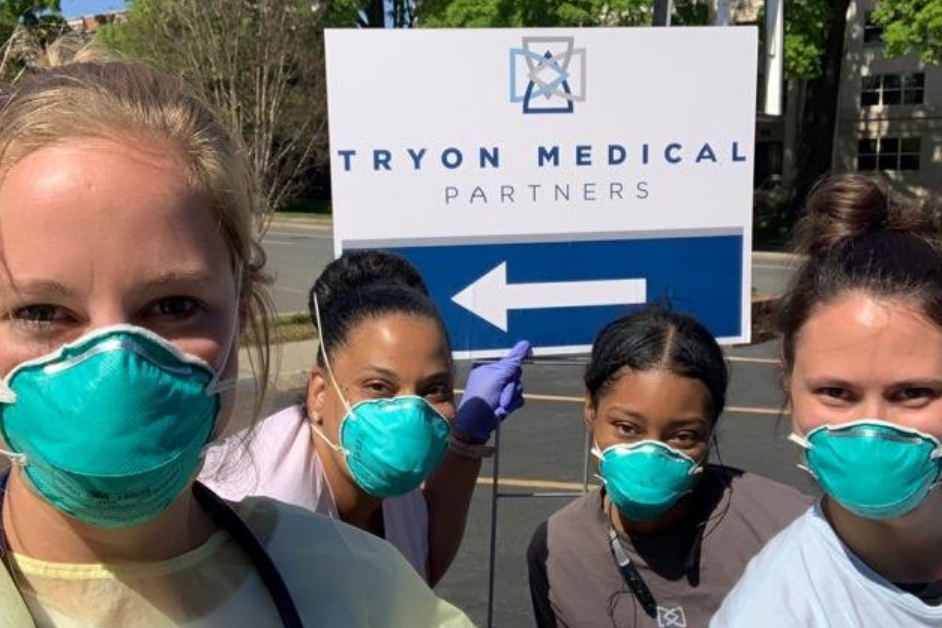 Tryon Medical Partners doctors and nurses pose outside a satellite testing facility for COVID-19